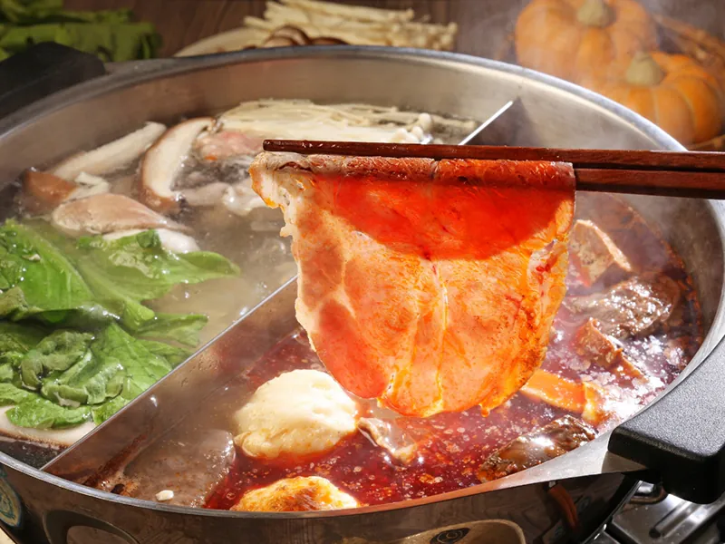 Juicy pork belly slice boiled in twin-flavor hot pot at KTOP Korean BBQ and Hot Pot, an Asian Restaurant in Longview
