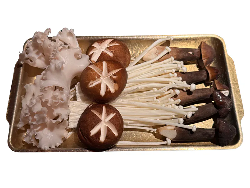 Assorted fresh mushrooms served on a golden tray at KTOP Korean BBQ and Hot Pot, an Asian Restaurant in Longview