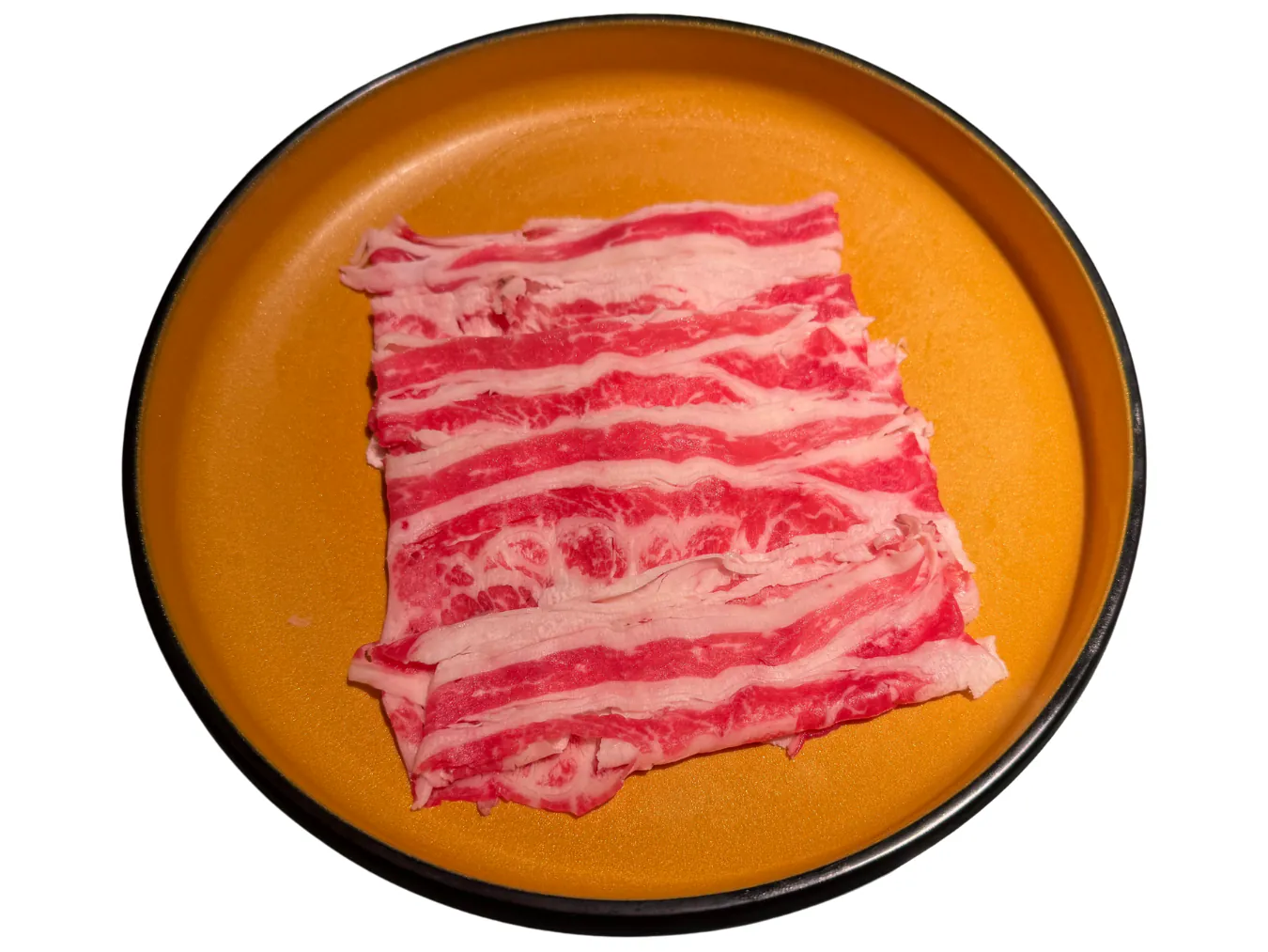 Marbled beef belly slices arranged on a golden plate at KTOP Korean BBQ and Hot Pot, an Asian Restaurant in Longview